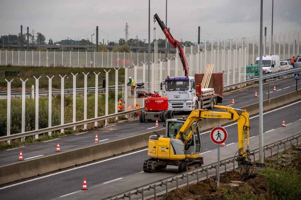 Seven-metre fencing goes up along the access route to the Eurotunnel to try and prevent migrants from trying to cross into Britain. October, 2015. Seven-metre fencing goes up along the access route to the Eurotunnel to try and prevent migrants from trying to cross into Britain. October, 2015.