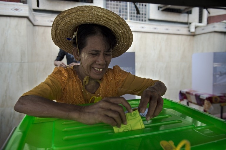 A woman smiles as she casts her ballot in the November 8 poll. A woman smiles as she casts her ballot in the November 8 poll.
