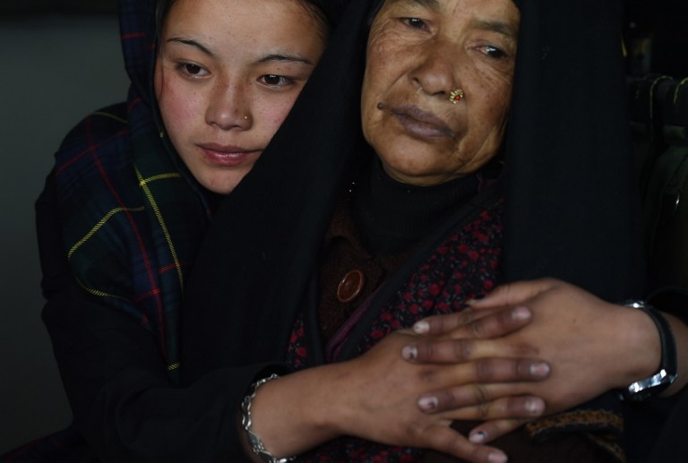 An injured Nepalese mother and daughter sit inside an Indian Army helicopter after being rescued from the north-central Laprak village on April 30, 2015 An injured Nepalese mother and daughter sit inside an Indian Army helicopter after being rescued from the north-central Laprak village on April 30, 2015