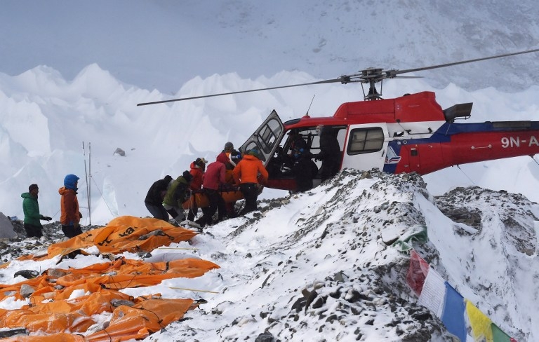 An injured person is loaded onto a rescue helicopter at Everest Base Camp on April 26, 2015, a day after an avalanche triggered by an earthquake devastated the camp An injured person is loaded onto a rescue helicopter at Everest Base Camp on April 26, 2015, a day after an avalanche triggered by an earthquake devastated the camp