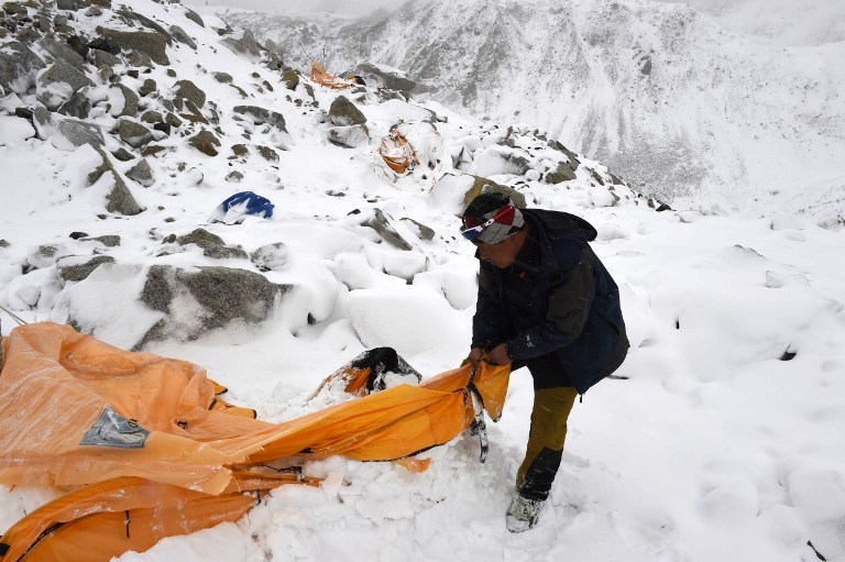 Expedition guide Pasang Sherpa searches through flattened tents for survivors after an avalanche flattened parts of Everest Base Camp on April 25, 2015 Expedition guide Pasang Sherpa searches through flattened tents for survivors after an avalanche flattened parts of Everest Base Camp on April 25, 2015