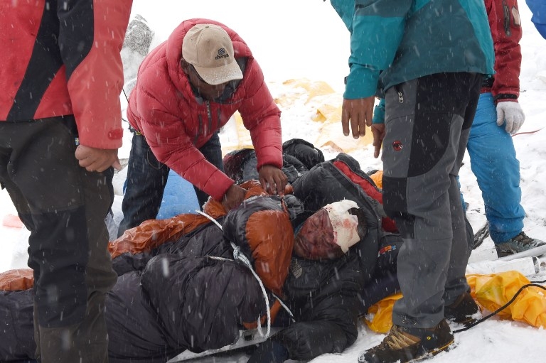 Rescuers tend to a sherpa injured during an avalanche at Everest Base Camp on April 25, 2015 Rescuers tend to a sherpa injured during an avalanche at Everest Base Camp on April 25, 2015