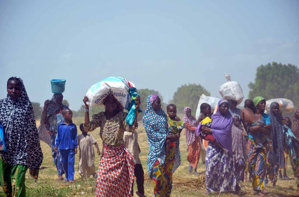 Women and children flee after Boko Haram burned down their village near Maiduguri. Women and children flee after Boko Haram burned down their village near Maiduguri.