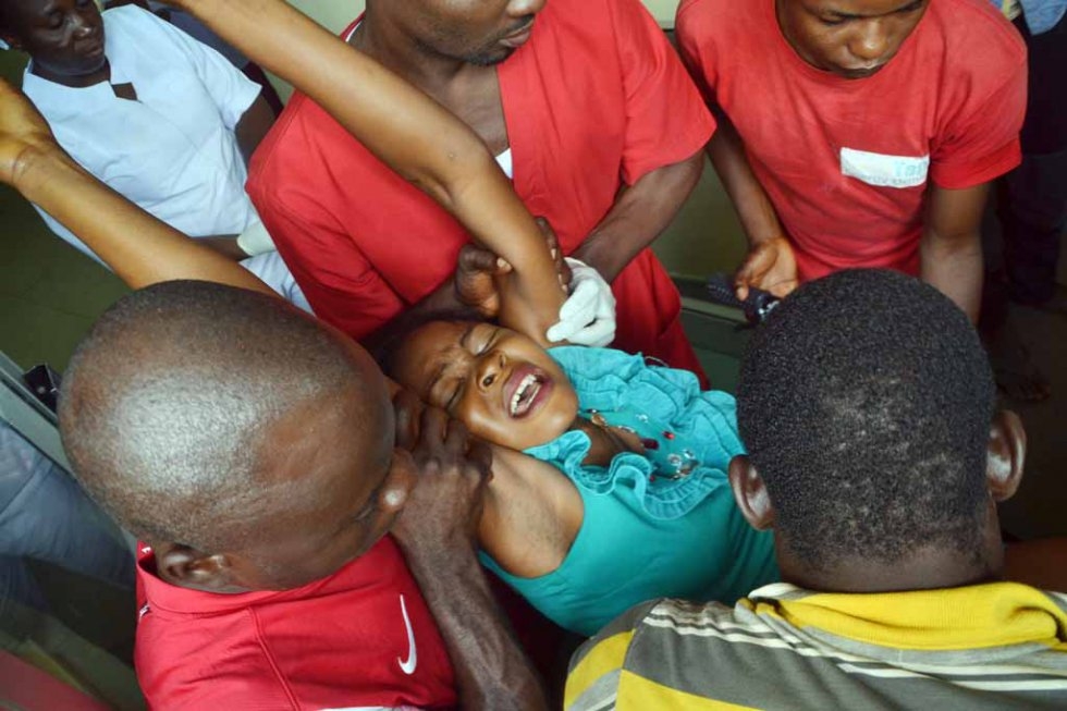 Rescuers carry a victim away from a scene of multiple explosions in Abuja, October, 2015. Rescuers carry a victim away from a scene of multiple explosions in Abuja, October, 2015.