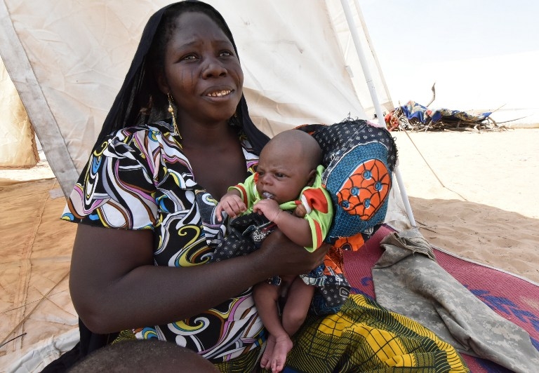Nigerian refugee Aisha Aladji Garb and her newborn son in a UNHCR camp by Lake Chad on January 26, 2015 Nigerian refugee Aisha Aladji Garb and her newborn son in a UNHCR camp by Lake Chad on January 26, 2015