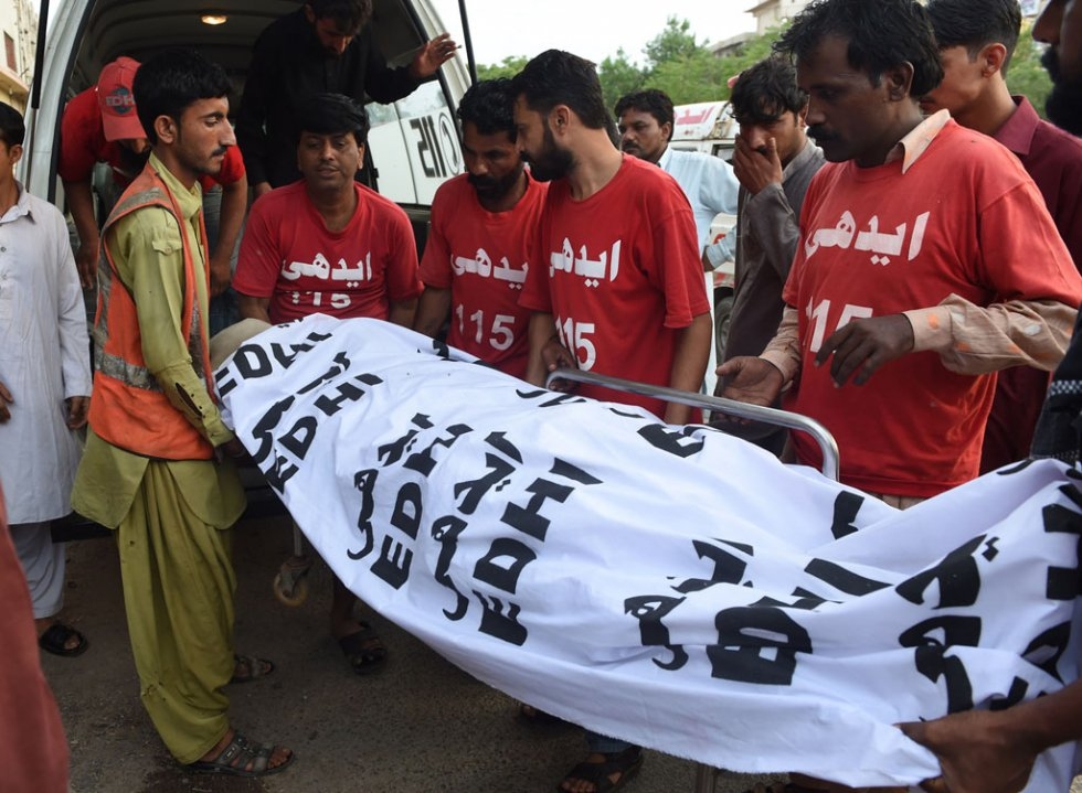 Volunteers take the body of Shafqat Hussain to a mortuary after his execution in Karachi on August 4, 2015 Volunteers take the body of Shafqat Hussain to a mortuary after his execution in Karachi on August 4, 2015