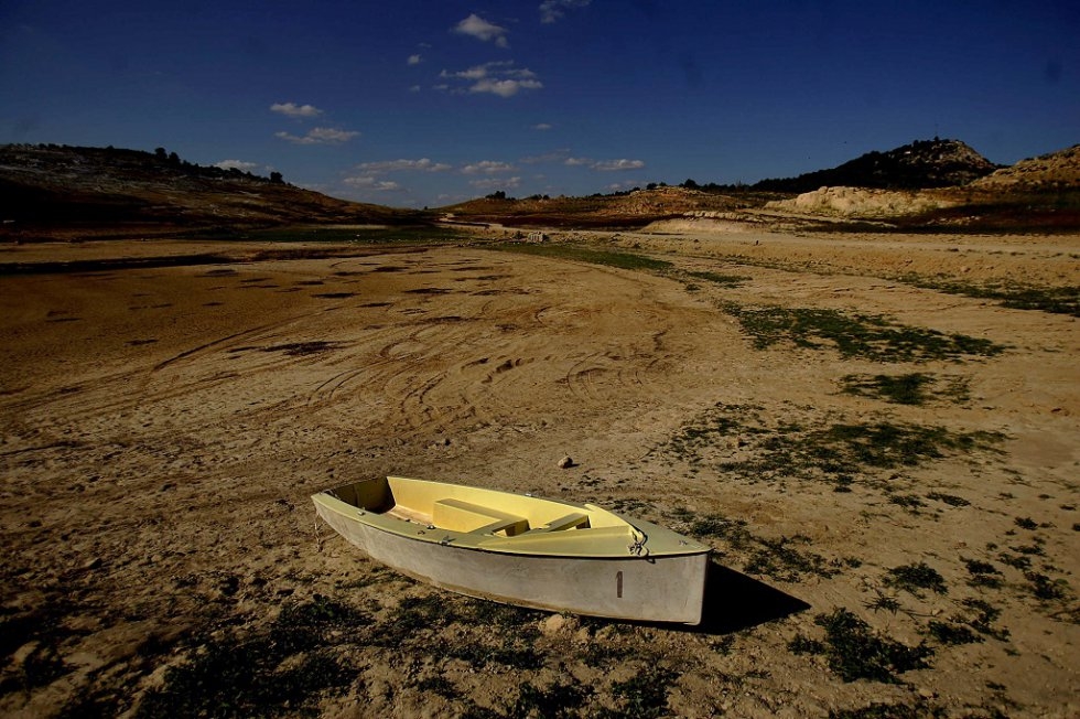 A boat in a dried-up reservoir in Spain. August, 2006. A boat in a dried-up reservoir in Spain. August, 2006.