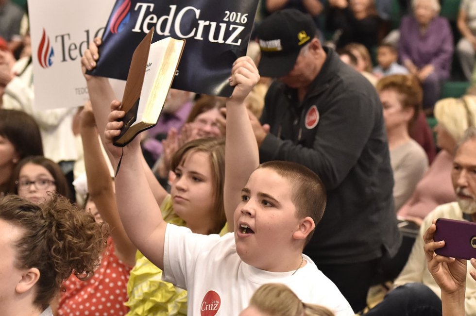 Rhett Sullivan, 10, holds up a Bible while Republican presidential candidate Ted Cruz speaks at a campaign event in Las Vegas, Nevada on February 22, 2016 Rhett Sullivan, 10, holds up a Bible while Republican presidential candidate Ted Cruz speaks at a campaign event in Las Vegas, Nevada on February 22, 2016