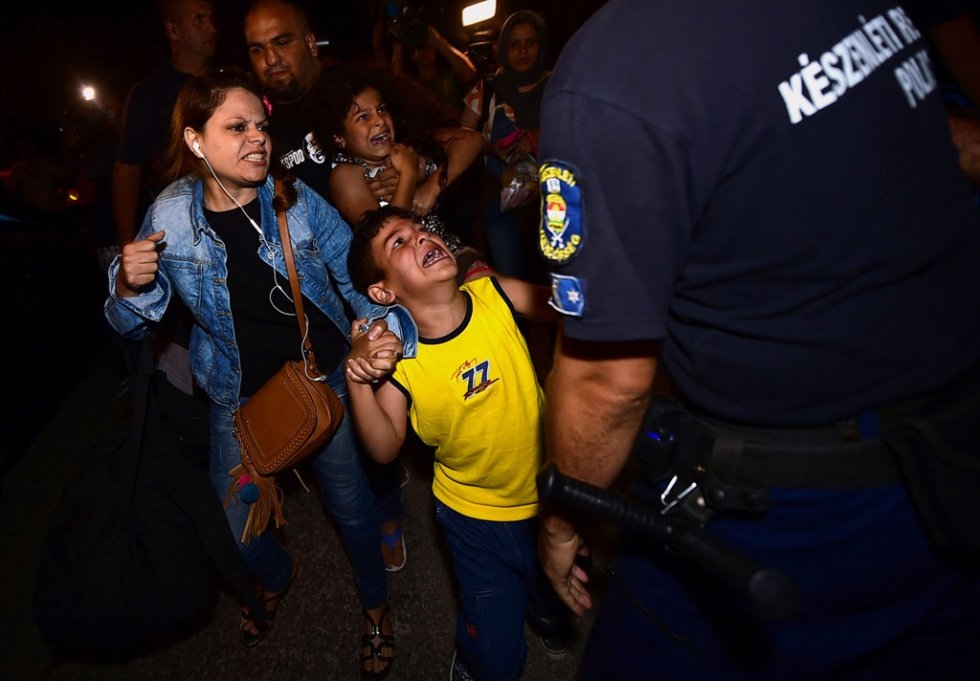 A migrant family is taken by the police to a refugee camp in Bicske, Hungary, on September 3, 2015 A migrant family is taken by the police to a refugee camp in Bicske, Hungary, on September 3, 2015