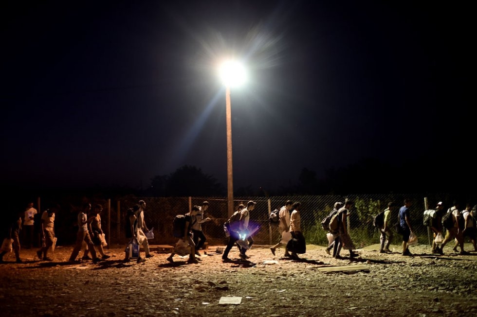 Migrants walk to catch a train after crossing the border from Greece to Macedonia at the village of Gevgelija on August 29, 2015 Migrants walk to catch a train after crossing the border from Greece to Macedonia at the village of Gevgelija on August 29, 2015