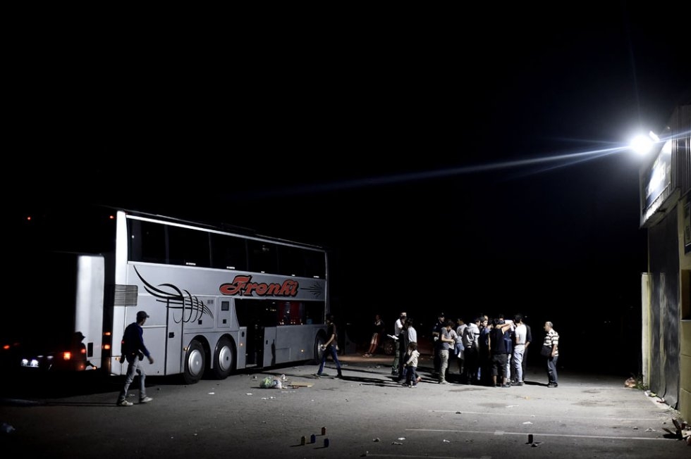 A group of Syrian refugees and migrants board a bus to travel from Presevo to Belgrade late on August 30, 2015 A group of Syrian refugees and migrants board a bus to travel from Presevo to Belgrade late on August 30, 2015