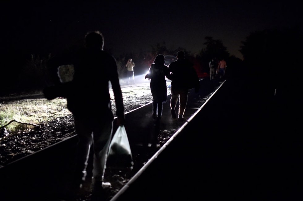 Syrian refugees and migrants along a railway line as they try to cross from Serbia into Hungary near Horgos late on September 1, 2015 Syrian refugees and migrants along a railway line as they try to cross from Serbia into Hungary near Horgos late on September 1, 2015