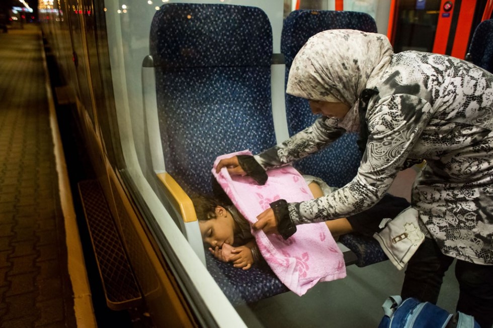 A migrant child sleeps on the train from Budapest to Vienna at the Austrian - Hungarian border in Hegyeshalom on August 31, 2015 A migrant child sleeps on the train from Budapest to Vienna at the Austrian - Hungarian border in Hegyeshalom on August 31, 2015