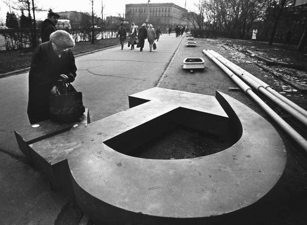A photo from 1991 shows a woman next to removed Soviet symbols in Moscow. A photo from 1991 shows a woman next to removed Soviet symbols in Moscow.