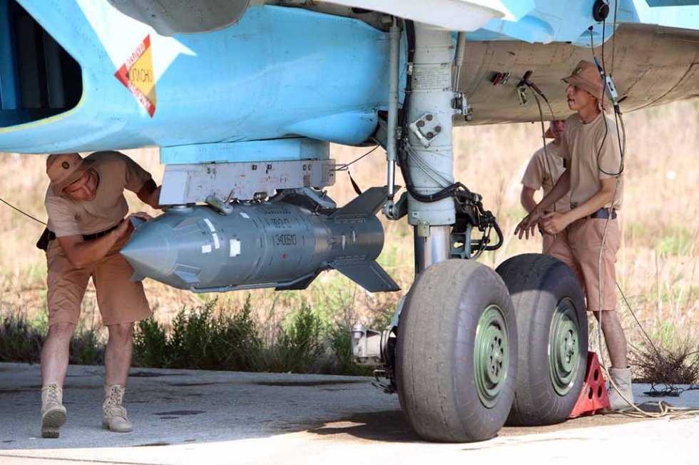 Soldiers check a Russian fighter jet before takeoff in Syria. Soldiers check a Russian fighter jet before takeoff in Syria.