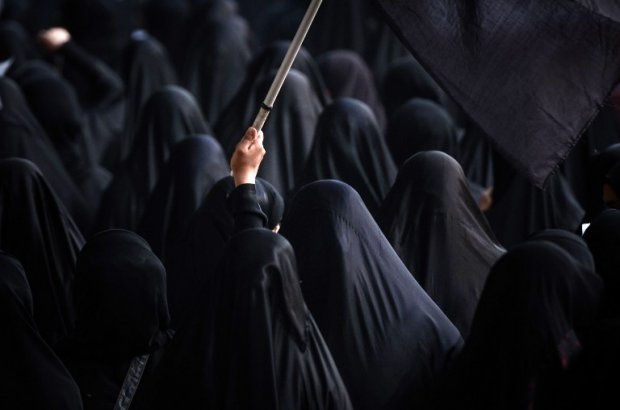 A woman waves a flag during the funeral of Sadeq Sabt, in the village of North Sehla, west of Manama, on September 1, 2013. Sabt, 22, died of his injuries after he was hit by a vehicle during a protest a month before A woman waves a flag during the funeral of Sadeq Sabt, in the village of North Sehla, west of Manama, on September 1, 2013. Sabt, 22, died of his injuries after he was hit by a vehicle during a protest a month before