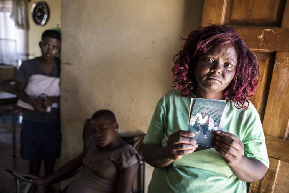 Seun Tangasha's sister holds up a photo of him. February 12, 2016. Seun Tangasha's sister holds up a photo of him. February 12, 2016.
