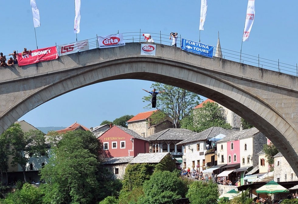 A Bosnian high diver jumps from the 'Stari Most' during a competition in Mostar on July 26, 2015 A Bosnian high diver jumps from the 'Stari Most' during a competition in Mostar on July 26, 2015