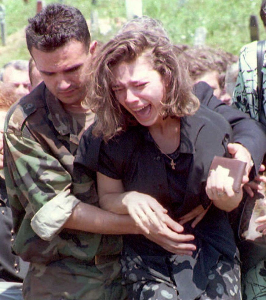 The sister of a Bosnian Croat soldier killed on the frontline in Sarajevo grieves at her brother's funeral on August 7, 1995 The sister of a Bosnian Croat soldier killed on the frontline in Sarajevo grieves at her brother's funeral on August 7, 1995