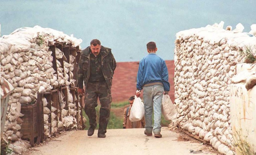A Bosnian soldier crosses a protected bridge over the Dobrinja river, south eastern Sarajevo, on June 25, 1995 A Bosnian soldier crosses a protected bridge over the Dobrinja river, south eastern Sarajevo, on June 25, 1995