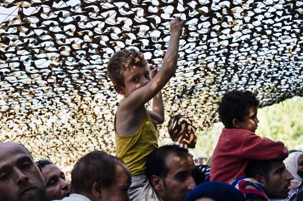 Families wait to apply for asylum and legalise their stay in Serbia for 72 hours, at a migrant centre in Presevo on July 16, 2015 Families wait to apply for asylum and legalise their stay in Serbia for 72 hours, at a migrant centre in Presevo on July 16, 2015