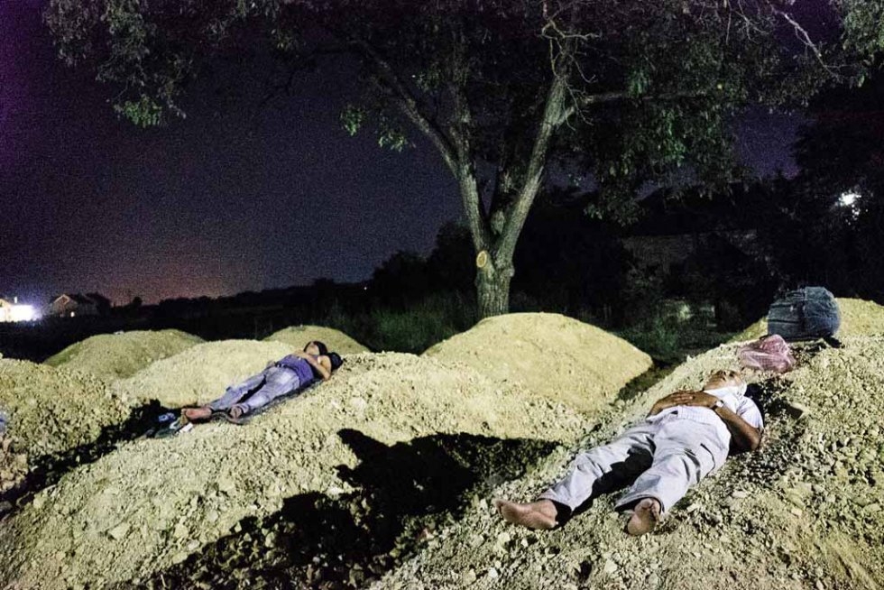 Migrants sleep in the southern Serbian town of Presevo, near the border with Macedonia on July 16, 2015 Migrants sleep in the southern Serbian town of Presevo, near the border with Macedonia on July 16, 2015