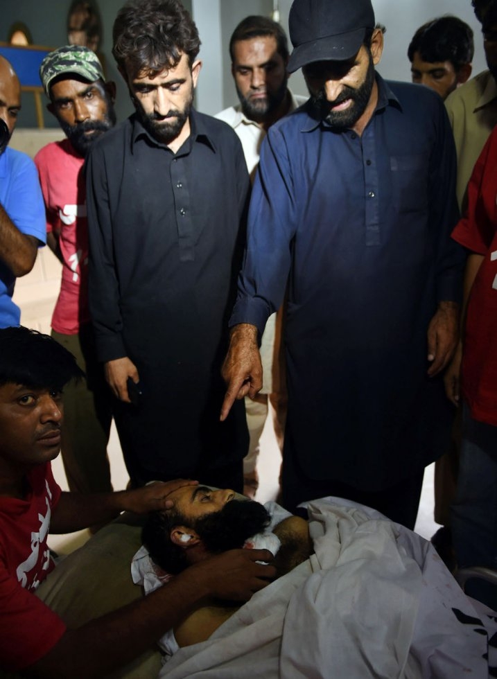 Relatives of Shafqat Hussain look at his body at a mortuary in Karachi on August 4 Relatives of Shafqat Hussain look at his body at a mortuary in Karachi on August 4