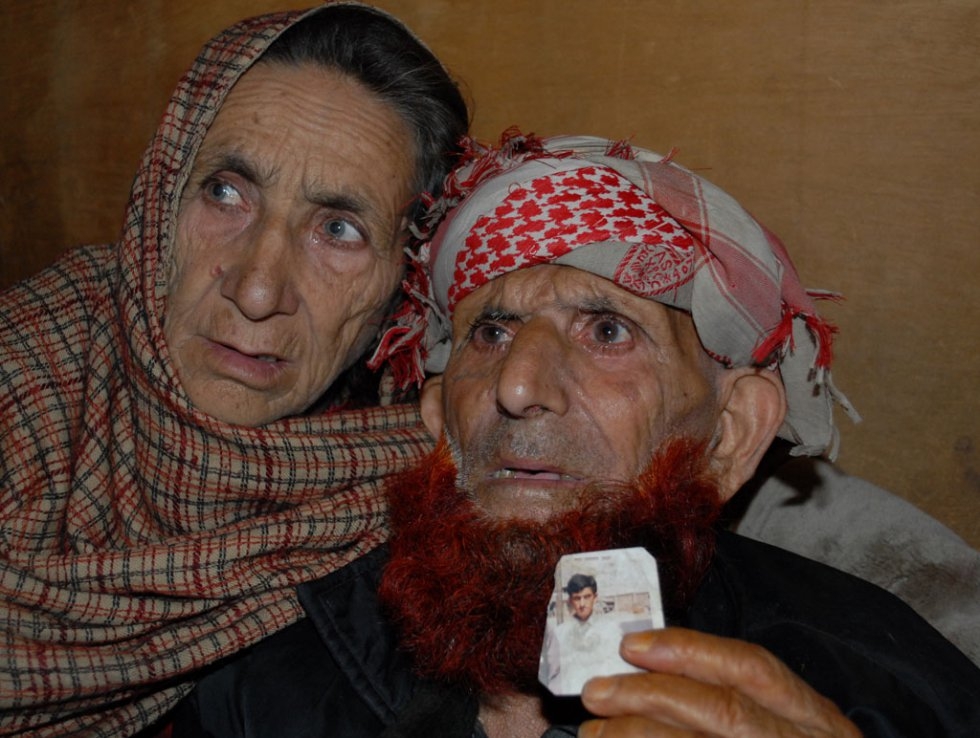 The parents of Shafqat Hussain display a picture of their son in March 2015 The parents of Shafqat Hussain display a picture of their son in March 2015