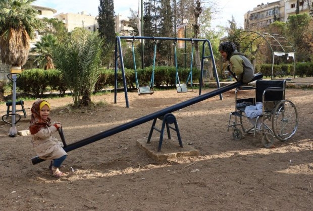 Shuruq (R), a nine-year old Syrian girl without legs, plays on a swing with another child in a park in the northern Syrian city of Aleppo on November 3, 2014 (AFP Photo / Baraa Al-Halabi) Shuruq (R), a nine-year old Syrian girl without legs, plays on a swing with another child in a park in the northern Syrian city of Aleppo on November 3, 2014 (AFP Photo / Baraa Al-Halabi)