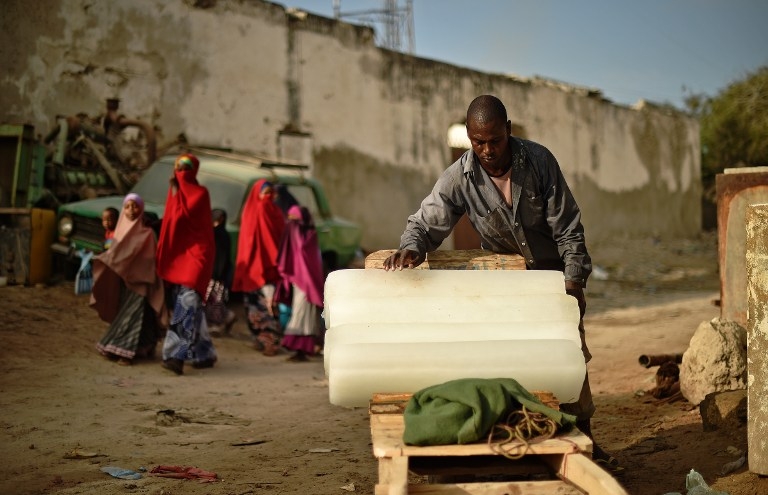A man loads blocks of ice onto a cart in Mogadishu on March 26, 2015 A man loads blocks of ice onto a cart in Mogadishu on March 26, 2015
