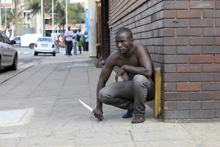 A foreign national holds a knife during a wave of xenophobic clashes in Durban on April 14, 2015 A foreign national holds a knife during a wave of xenophobic clashes in Durban on April 14, 2015