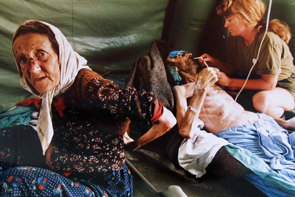An elderly Muslim couple are treated for injuries inflicted by Serb forces as they fled Srebrenica. The man on the right died shortly afterwards. An elderly Muslim couple are treated for injuries inflicted by Serb forces as they fled Srebrenica. The man on the right died shortly afterwards.