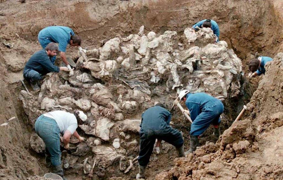 ICTY investigators work on top of a cluster of bodies, many of them with their hands tied in the back and blindfolded, at a mass grave outside Pilica, some 55 km east of Tuzla on 18 September, 1996 ICTY investigators work on top of a cluster of bodies, many of them with their hands tied in the back and blindfolded, at a mass grave outside Pilica, some 55 km east of Tuzla on 18 September, 1996