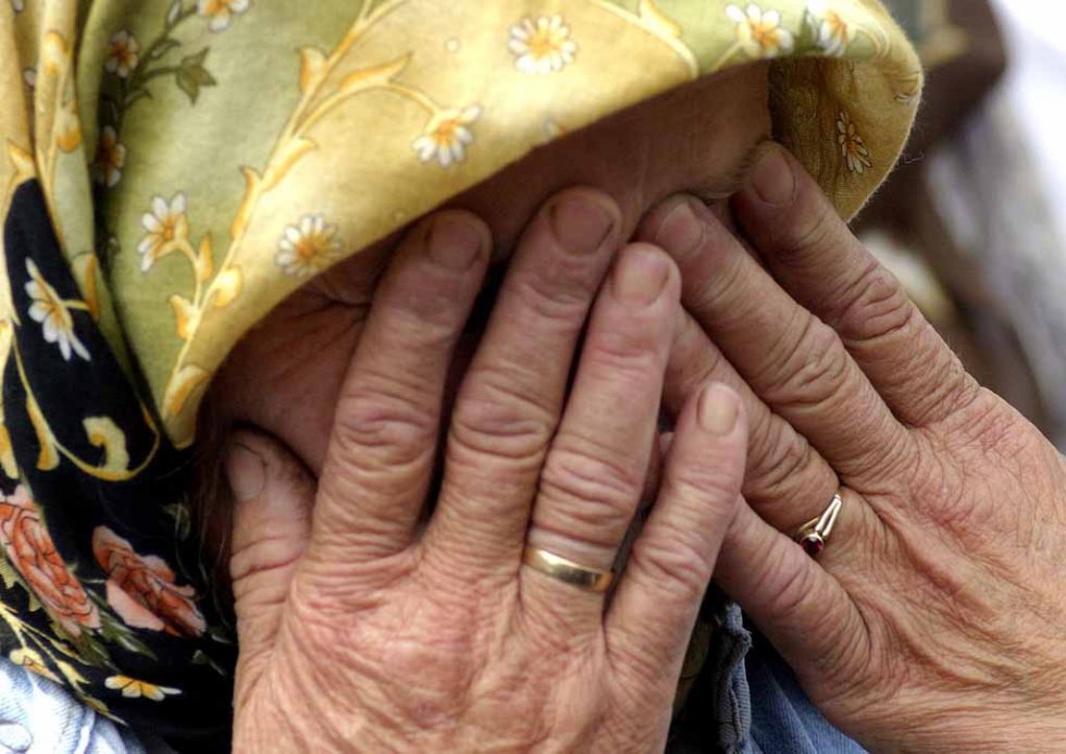 A Bosnian Muslim woman wipes her tears while around 300 recently identified bodies of Bosnian Muslim men are transported from Sarajevo to Srebrenica, 09 July, 2003 A Bosnian Muslim woman wipes her tears while around 300 recently identified bodies of Bosnian Muslim men are transported from Sarajevo to Srebrenica, 09 July, 2003