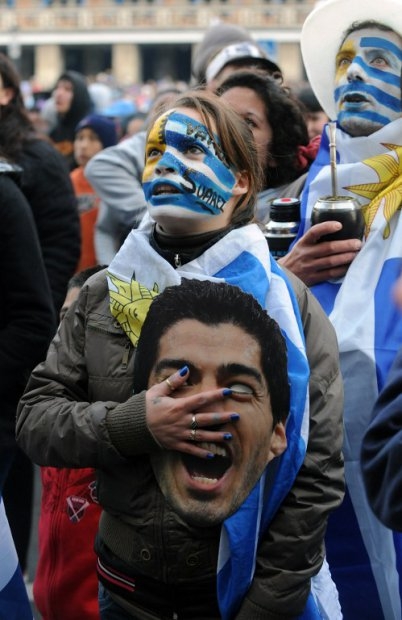 A Uruguayan woman sings the national anthem in Montevideo as Uruguay-Colombia match is broadcast live, June 28, 2014. A Uruguayan woman sings the national anthem in Montevideo as Uruguay-Colombia match is broadcast live, June 28, 2014.