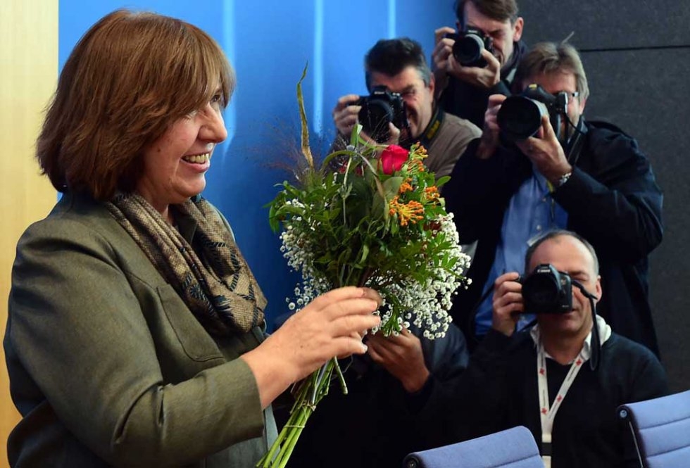 The laureate of the 2015 Nobel Literature Prize, Belarussian writer and dissident Svetlana Alexievich, receives a bunch of flowers from well-wishers prior to a press conference in Berlin, on October 10, 2015 The laureate of the 2015 Nobel Literature Prize, Belarussian writer and dissident Svetlana Alexievich, receives a bunch of flowers from well-wishers prior to a press conference in Berlin, on October 10, 2015