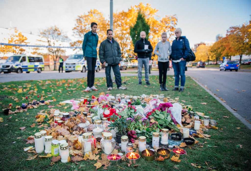 Candles and flowers outside the attacked school. Candles and flowers outside the attacked school.
