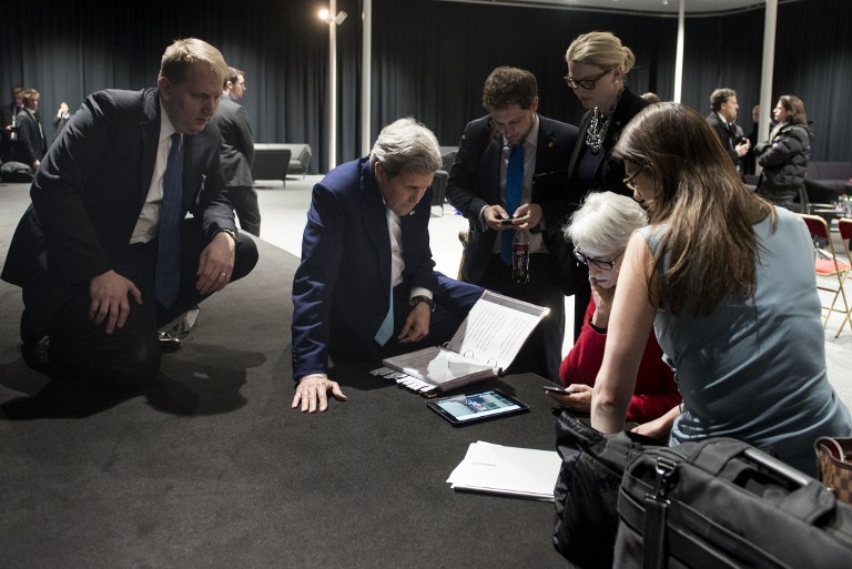 US Secretary of State John Kerry watches on a tablet device as US President Barack Obama addresses the nation after the end of Iran nuclear talks in Lausanne on April 2, 2015 US Secretary of State John Kerry watches on a tablet device as US President Barack Obama addresses the nation after the end of Iran nuclear talks in Lausanne on April 2, 2015