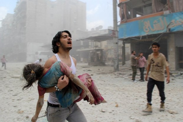 A man carries a young girl who was injured in a barrel-bomb attack by government forces on June 3, 2014 in Kallaseh district in the northern city of Aleppo A man carries a young girl who was injured in a barrel-bomb attack by government forces on June 3, 2014 in Kallaseh district in the northern city of Aleppo