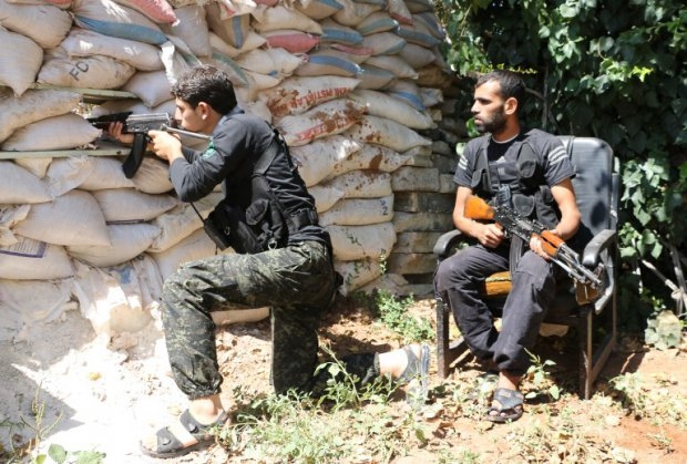 Fighters from the Nureddine al-Zinki unit, a moderate Syrian opposition faction affiliated with the Muslim Brotherhood, take position near Aleppo on Septembrer 11, 2014 Fighters from the Nureddine al-Zinki unit, a moderate Syrian opposition faction affiliated with the Muslim Brotherhood, take position near Aleppo on Septembrer 11, 2014