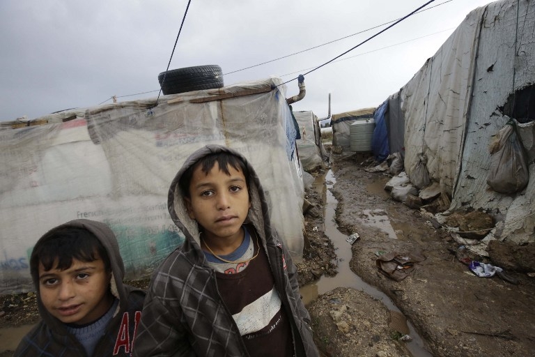 Syrian refugees at a camp damaged by a storm in Akkar, north Lebanon on January 7, 2015 Syrian refugees at a camp damaged by a storm in Akkar, north Lebanon on January 7, 2015