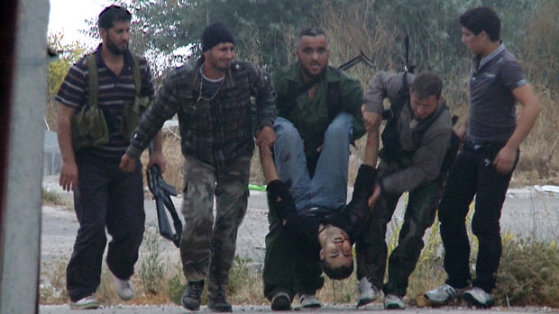 Syrian rebels carry the body of their slain comrade at Krak des Chevaliers in June 2012 Syrian rebels carry the body of their slain comrade at Krak des Chevaliers in June 2012