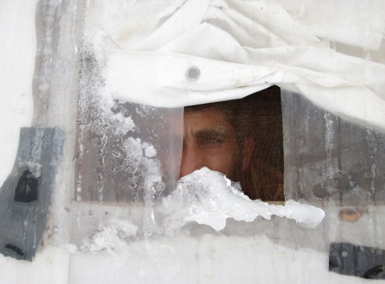 A Syrian refugee looks out of his tent in Lebanon's Bekaa valley, on January 7, 2015 A Syrian refugee looks out of his tent in Lebanon's Bekaa valley, on January 7, 2015