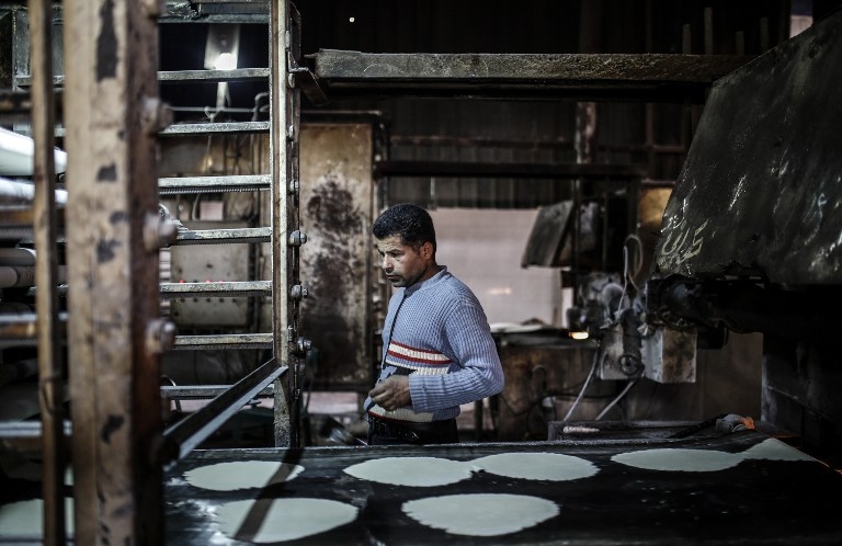 A Kurdish man works in a bread factory in Kobane on March 22, 2015 A Kurdish man works in a bread factory in Kobane on March 22, 2015