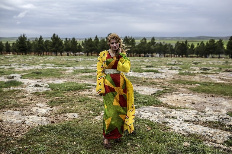 A Syrian Kurdish woman poses during a gathering to celebrate Newroz in Kobane on March 21, 2015. A Syrian Kurdish woman poses during a gathering to celebrate Newroz in Kobane on March 21, 2015.