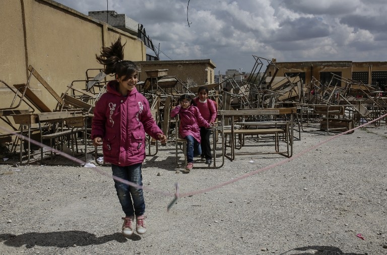 Schoolchildren play at recess outside their school in Kobane on March 25, 2015 Schoolchildren play at recess outside their school in Kobane on March 25, 2015