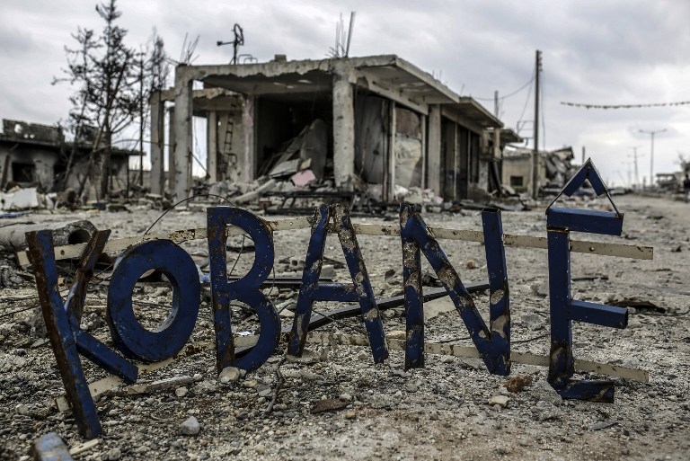 What's left of a 'Welcome to Kobane' sign at the town entrance on March 24, 2015 What's left of a 'Welcome to Kobane' sign at the town entrance on March 24, 2015