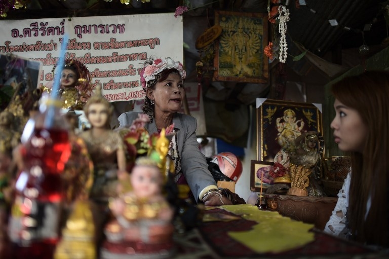 A fortune teller at a Bangkok shrine to the ghost 'Nak' on January 15, 2015 A fortune teller at a Bangkok shrine to the ghost 'Nak' on January 15, 2015