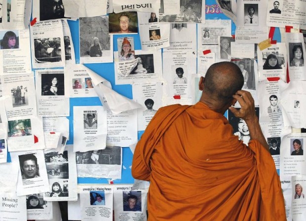 A Buddhist monk looks at missing person notices at Phuket hospital on January 5, 2005 A Buddhist monk looks at missing person notices at Phuket hospital on January 5, 2005