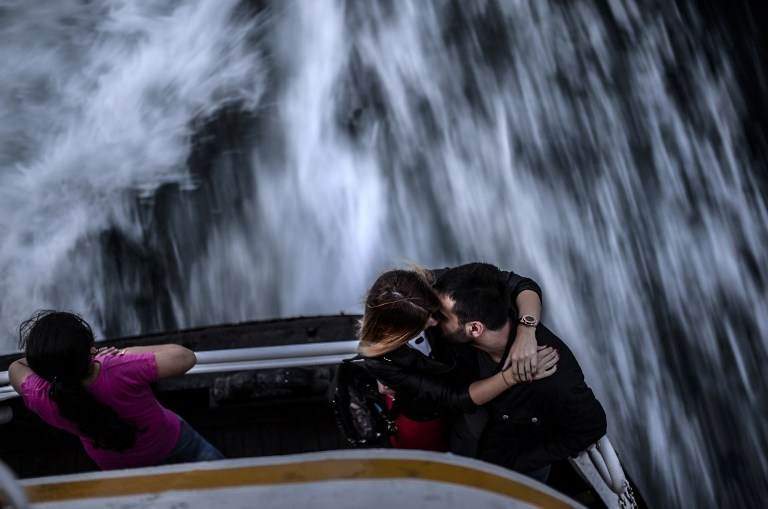A Turkish couple shares a romantic sunset at the back of a ferry on the Bosphorus in October 2014 A Turkish couple shares a romantic sunset at the back of a ferry on the Bosphorus in October 2014